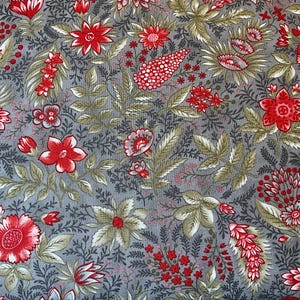 May include: A fabric with a floral pattern featuring red flowers and green leaves on a gray background. The design includes various flower shapes and sizes, creating a detailed and visually appealing textile.
