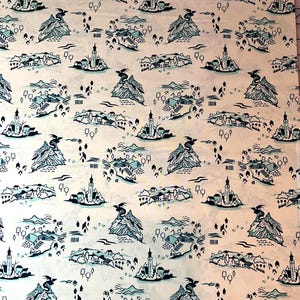 May include: A fabric with a repeating pattern of fantasy landscapes in shades of blue and white. The design includes mountains, castles, dragons, and small villages, creating a whimsical, storybook aesthetic.