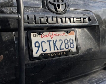 Toyota License Plate Frame | Gold Lettering, White Aluminum
