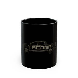 May include: Black ceramic mug with a white outline of a pickup truck and the word "TACOMA" printed on the side.