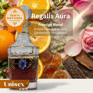 May include: A clear glass perfume bottle with a dark red liquid and a blue flower design. The bottle is labeled "Regalis Aura, Prestige Blend" with ingredients listed. The image includes orange slices, rose petals, and the text "Unisex."
