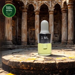 May include: A small glass bottle with a white dropper top, containing a yellow liquid. The bottle is labeled "1 ML" and is set against a blurred background. A green circular logo with the words "100% NATURAL" is in the upper left corner.