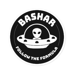 May include: A round sticker with a black background featuring a white UFO with an alien inside. The word "BASHAR" is arched above the UFO, and "FOLLOW THE FORMULA" is arched below. The design is a simple, bold graphic.