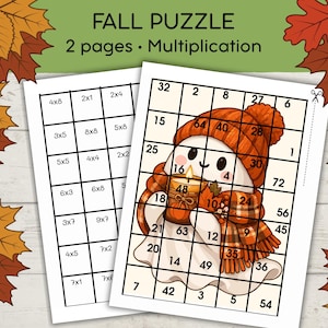 May include: A two-page multiplication maths puzzle worksheet featuring a grid layout. One page shows multiplication equations, while the other displays a grid with numbers overlaid on an illustration of a ghost wearing an orange knit hat and scarf.