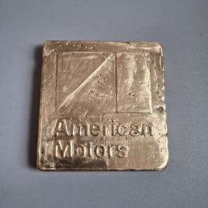 Logo AMC in bronzo alluminio