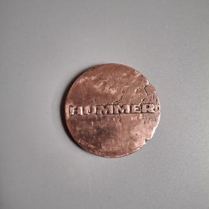 Copper hummer logo medallion