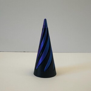 May include: A black cone with a swirling blue and purple iridescent pattern.