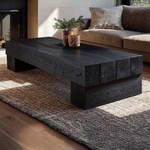 May include: A contemporary living room with a dark wooden coffee table, approximately 150cm long, on a textured rug. A sofa and fireplace are in the background. The table has decorative vases with greenery on top.