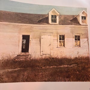 May include: Watercolour painting of a white, weathered building with a dark roof and two dormer windows. The building has a door and two windows. Tall, dry grass is in the foreground.