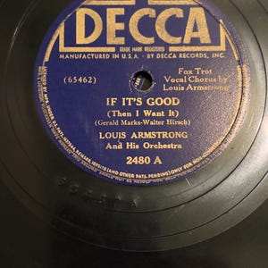May include: A blue and gold vinyl record with the text "DECCA" in large letters. The record is titled "IF IT'S GOOD (Then I Want It)" by Louis Armstrong and His Orchestra. The record number is 2480 A.