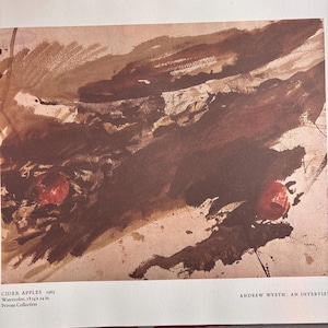 May include: Watercolor painting titled "Cider Apples 1963" by Andrew Wyeth. The artwork features a blend of brown and reddish hues, with two prominent red apple shapes. The painting is 47.6 x 61 cm.