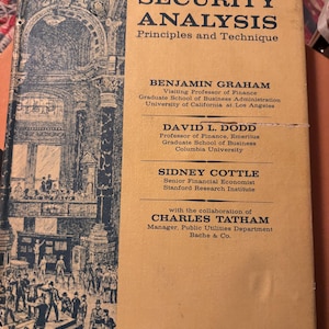 May include: A vintage book titled "Security Analysis: Principles and Technique" with a beige cover. The cover features the title in bold black letters, author names, and a detailed illustration of a building with people. The book is a fourth edition.