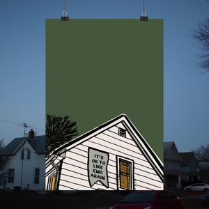 Può includere: Una casa bianca con un tetto verde e un cartello che dice "It's OK to Like Emo Again". La casa è di fronte a uno sfondo verde.