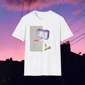 May include: White t-shirt with a graphic of a purple chess clock and chess pieces. The text "brandnew" is printed in red on the graphic.