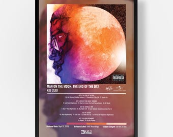 May include: A framed music poster for Kid Cudi's album Man on the Moon: The End of the Day. The artwork features a large orange moon and a profile illustration of a person. The poster includes a tracklist, release date, and record label info.