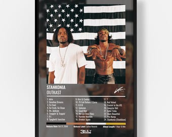 May include: A framed poster featuring the Outkast album Stankonia. The image shows two individuals in front of a black and white American flag. Below, a tracklist includes songs like Ms. Jackson and B.O.B, with release details from October 31, 2000.