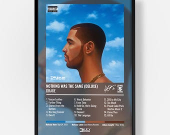 May include: A framed poster of the Drake album Nothing Was The Same (Deluxe) featuring a profile portrait of the artist against a blue sky. The print includes a tracklist of fifteen songs, the release date of Sept 24, 2013, and Cash Money Records logo.