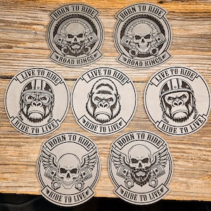 May include: Seven circular patches featuring black and white graphic designs. Two patches show a skull with a beard and pistons with the text BORN TO RIDE ROAD KINGS. Three patches show a gorilla with the text LIVE TO RIDE RIDE TO LIVE. Two patches show a skull with wings and pistons with the text BORN TO RIDE RIDE TO LIVE.