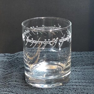 May include: A clear glass tumbler with the inscription "One Ring to rule them all, One Ring to find them, One Ring to bring them all and in the darkness bind them" etched around the side.