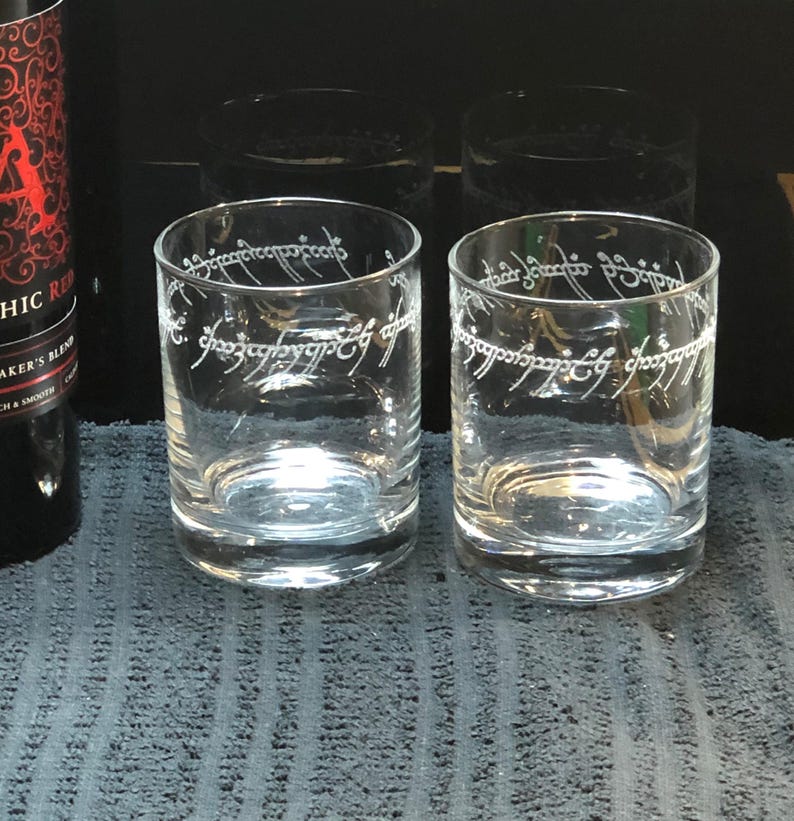 May include: Two clear glass tumblers with the inscription "One Ring to rule them all, One Ring to find them, One Ring to bring them all and in the darkness bind them" etched around the top of each glass.