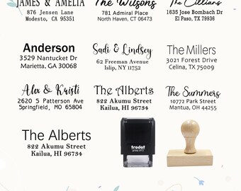 May include: A collection of personalized address stamps with various names and addresses, including "James & Amelia" and "The Alberts." A black Trodat stamp and a wooden stamp are also shown.