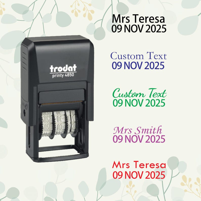 May include: A black trodat printy 4850 self-inking stamp with three date wheels. The stamp is on a white background with floral designs. The text on the stamp reads "trodat printy 4850". The text on the background reads "Mrs Teresa 09 NOV 2025", "Custom Text 09 NOV 2025", "Custom Text 09 NOV 2025", "Mrs Smith 09 NOV 2025", and "Mrs Teresa 09 NOV 2025".