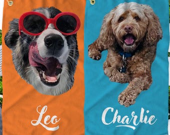 May include: Two golf towels with dog portraits. The towel on the left is orange with a black and white dog wearing red sunglasses. The towel on the right is blue with a brown dog. The text "Leo" is on the orange towel and "Charlie" is on the blue towel.