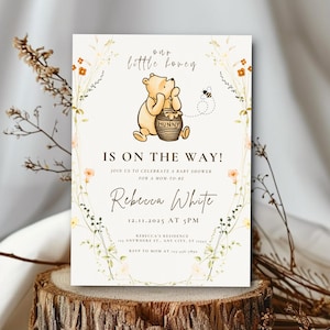 May include: A baby shower invitation with a Winnie the Pooh illustration and the text "Our Little Honey Is On The Way!". The invitation includes details for Rebecca White's baby shower on 12.11.2025 at 5 PM, with floral and bee accents around the edges.