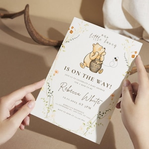 May include: A baby shower invitation with a Winnie the Pooh illustration and the text "Our little honey is on the way!" The invitation includes the name Rebecca White and the date 12.11.2025 at 3 PM. Floral and bee illustrations decorate the edges.