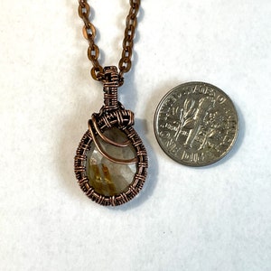 Small rutilated quartz pendant with woven wire setting size comparison