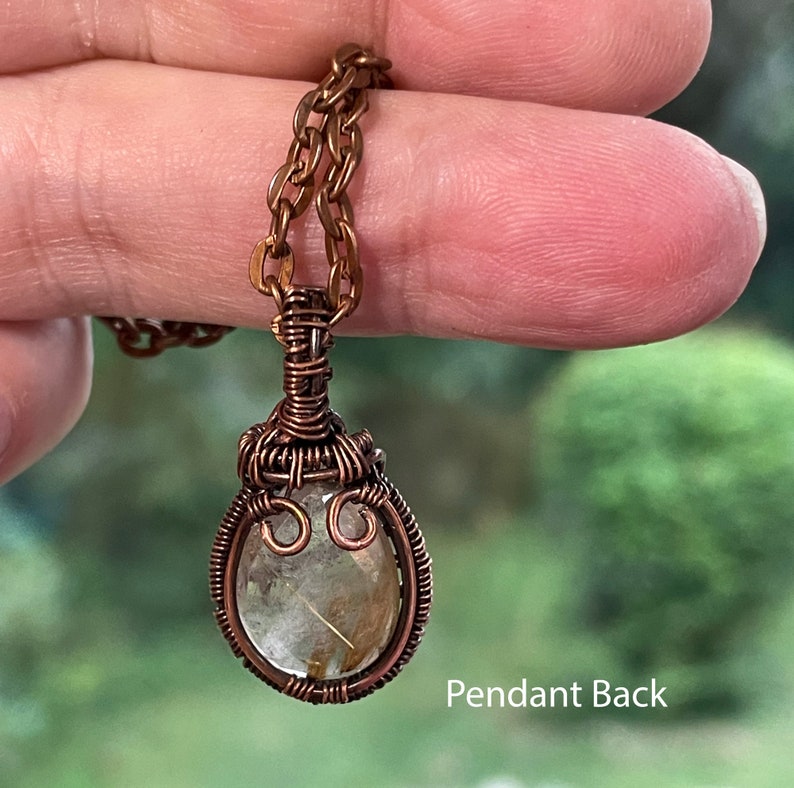 Small rutilated quartz pendant with woven wire setting with copper chain shown from the back