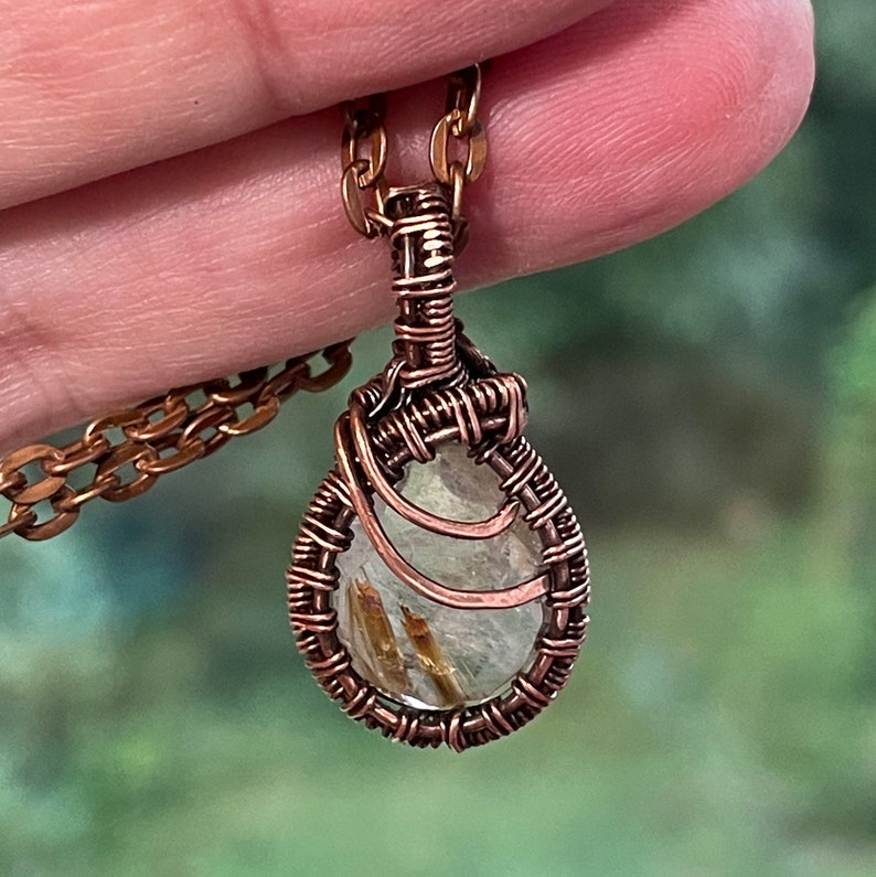 Small rutilated quartz pendant with woven wire setting with copper chain