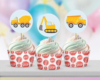 May include: Three cupcakes decorated with construction vehicle toppers. The toppers are yellow and orange and feature a cement mixer, a dump truck, and an excavator. The cupcakes are topped with green and white frosting and are sitting on a white surface.