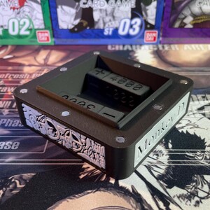 May include: Black dice tray with a raised edge and a compartment for dice. The tray has a white label on the side that says "Monkey D".