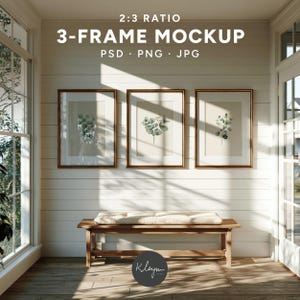 May include: A 2:3 ratio 3-frame mockup featuring three rectangular frames with thin brown borders hanging on a white horizontal paneled wall. Each frame displays a botanical illustration of green eucalyptus leaves on a light beige background.