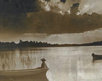 Vintage Real Photo Postcard RPPC - Young Boy Seated in Boat with Lake and Horizon Behind Him - Beautiful Lighting - 1910s - Sepia