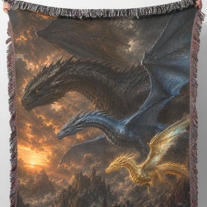 May include: Woven throw blanket featuring a fantasy scene with three dragons soaring through a sunset sky. The dragons are black, blue, and gold, with a detailed landscape below. The blanket has a fringed edge.