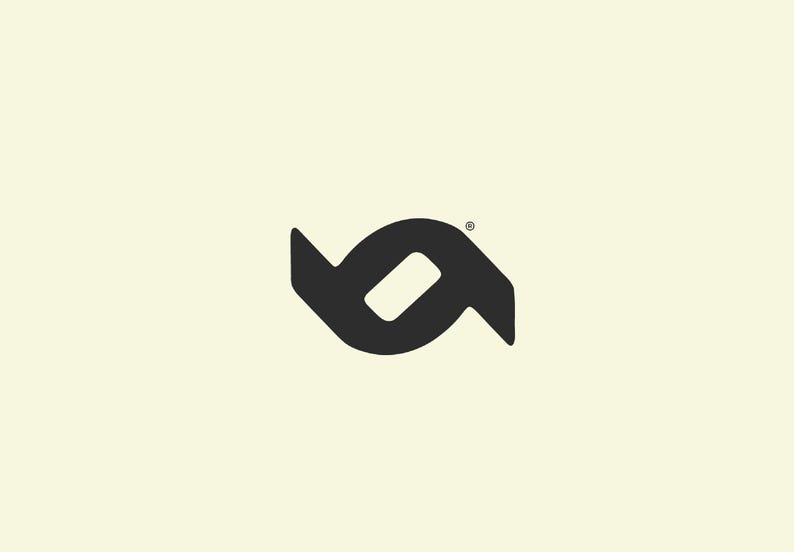 May include: A black logo on a cream background. The logo is a stylized, abstract design composed of two mirrored shapes, with a central, elongated oval. A small registered trademark symbol is in the upper right corner.