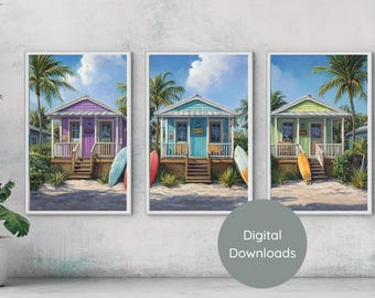 Pode incluir: Três impressões digitais de casas de praia coloridas com palmeiras e pranchas de surf. As casas são pintadas em tons de roxo, azul e verde. As impressões são perfeitas para adicionar um toque de charme costeiro à decoração da sua casa.