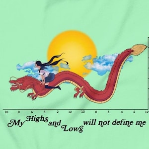 May include: Light green t-shirt featuring a red dragon with a person riding it, a yellow sun, and clouds. The text "My Highs and Lows will not define me" is printed at the bottom. A graph is on the right.