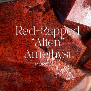 May include: Close-up of a red-capped amethyst crystal with the text "Red-Capped Alien Amethyst" and "MOROCCO". The crystal has a deep red color with darker spots and a textured surface.
