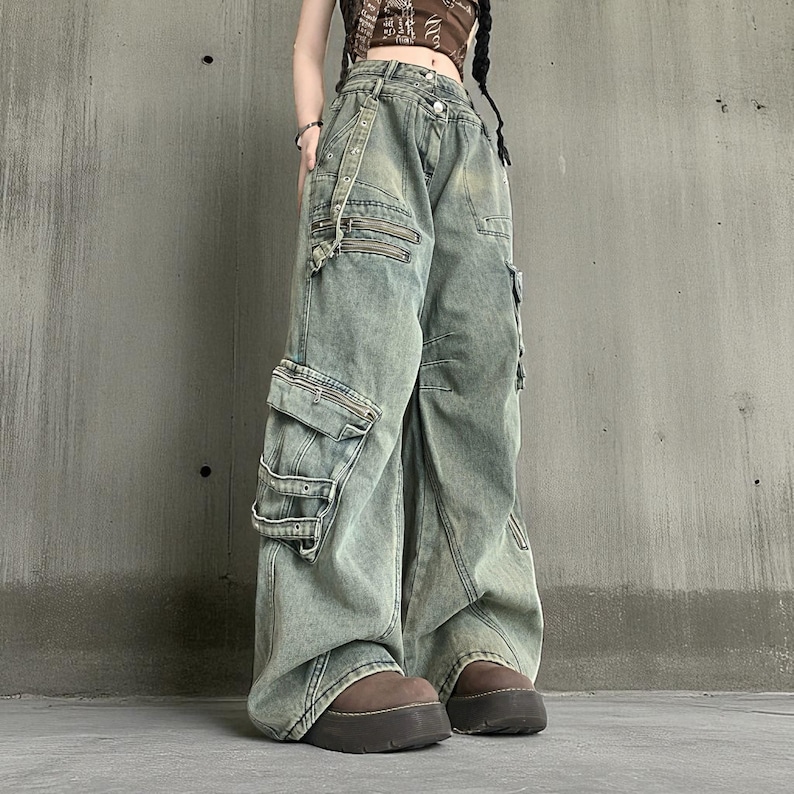 Baggy Cargo Pants | Streetwear Women Jeans | Wide Leg Style | Oversized Loose Pants
.
Women’s oversized cargo pants with wide-leg fit, buckle strap accents, zipper details, and multiple pockets styled in a Y2K streetwear look.
