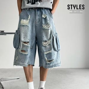 May include: Light blue denim cargo shorts with distressed detailing. The shorts feature large side pockets and ripped sections throughout. The text "STYLES BY LITO" is visible in the upper right corner.