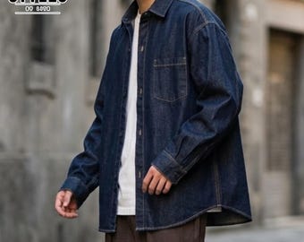 May include: A dark blue denim shirt with a button-down front and a single chest pocket. The shirt has long sleeves and a classic collar. The word "STYLES" is printed on the upper left corner of the image.