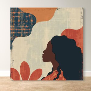 May include: Abstract art print featuring a woman's silhouette with long dark hair, a red and orange flower, and a geometric pattern in blue and orange.