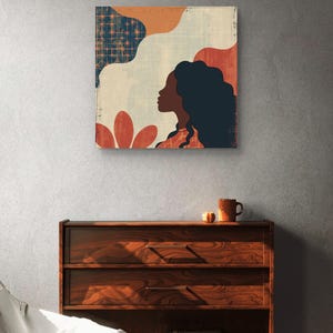 May include: Abstract art print featuring a woman's profile with long dark hair, set against a background of geometric shapes in shades of blue, orange, and red.