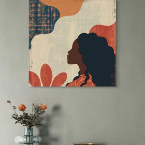 May include: Abstract art print featuring a woman's silhouette with long dark hair, a red flower, and geometric shapes in shades of orange, blue, and white.