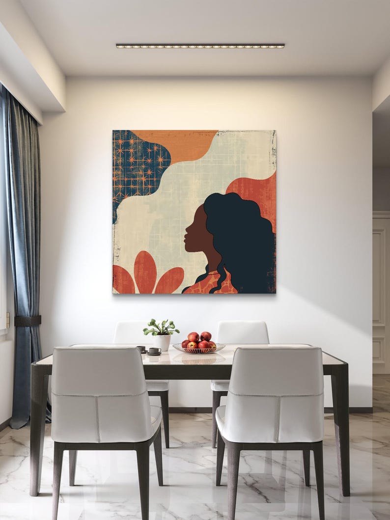 May include: Abstract art print featuring a woman's profile with a colorful background of red, orange, blue, and white. The print is hanging on a white wall above a dining table with two chairs.