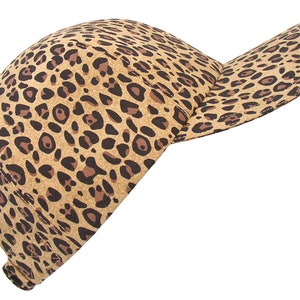 May include: A brown and black leopard print baseball cap.