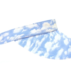May include: A blue visor with a white cloud print.